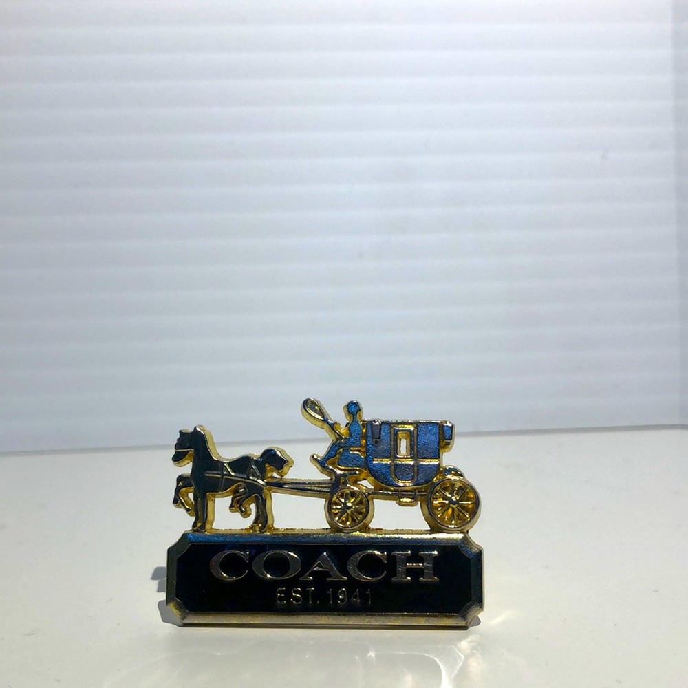 Coach metal pin.